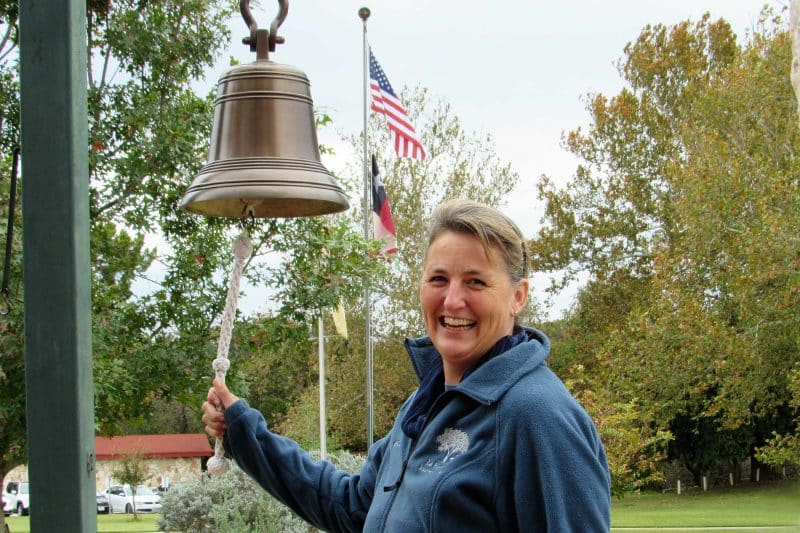 Rhonda Avans practices ringing the La Hacienda bell for Veterans Day observance.